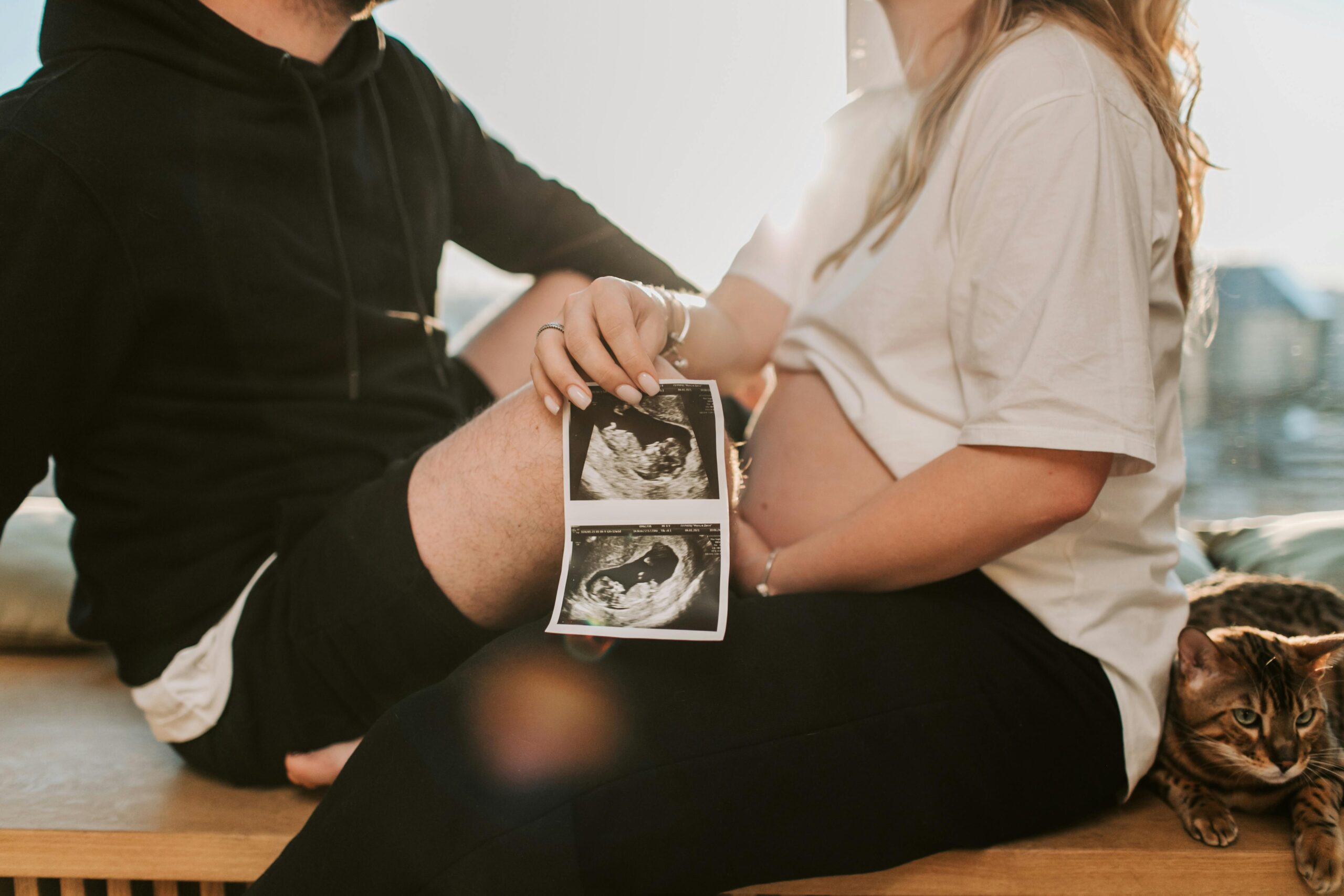 Pregnant family holding picture